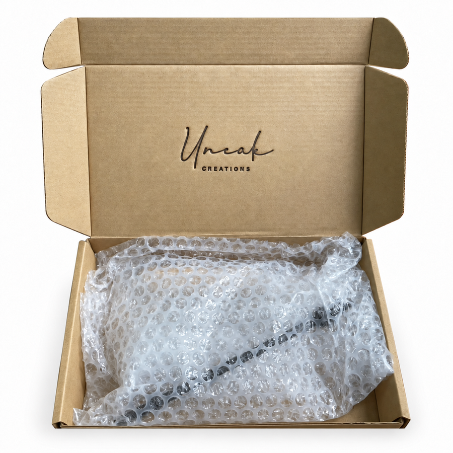 Our open Uneak Creations cardboard packaging with a directly heat-branded logo; retouched video still