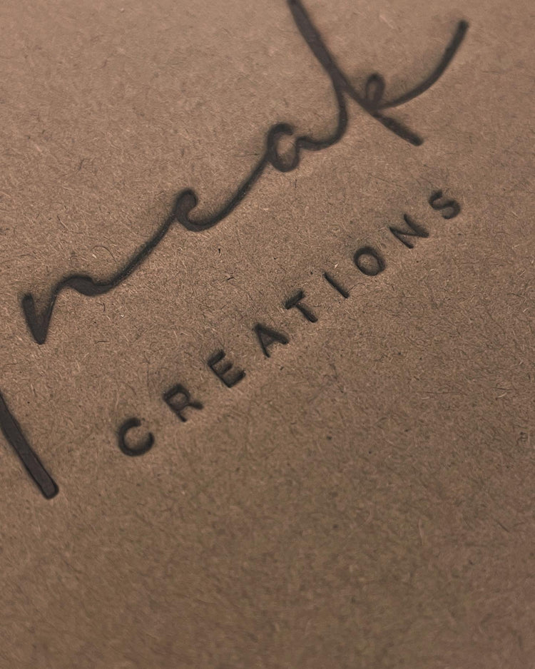 Our own cardboard packaging with the Uneak Creations logo heat branded into the surface