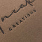 Real archival direct heat branding on Uneak Creations cardboard packaging; no foil